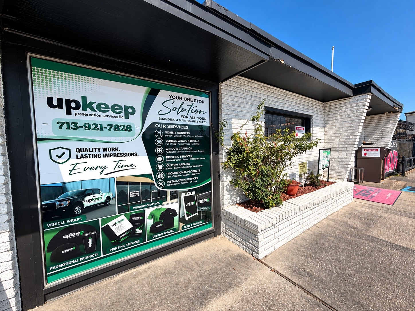 Green UpKeep window branding outside the Houston shop